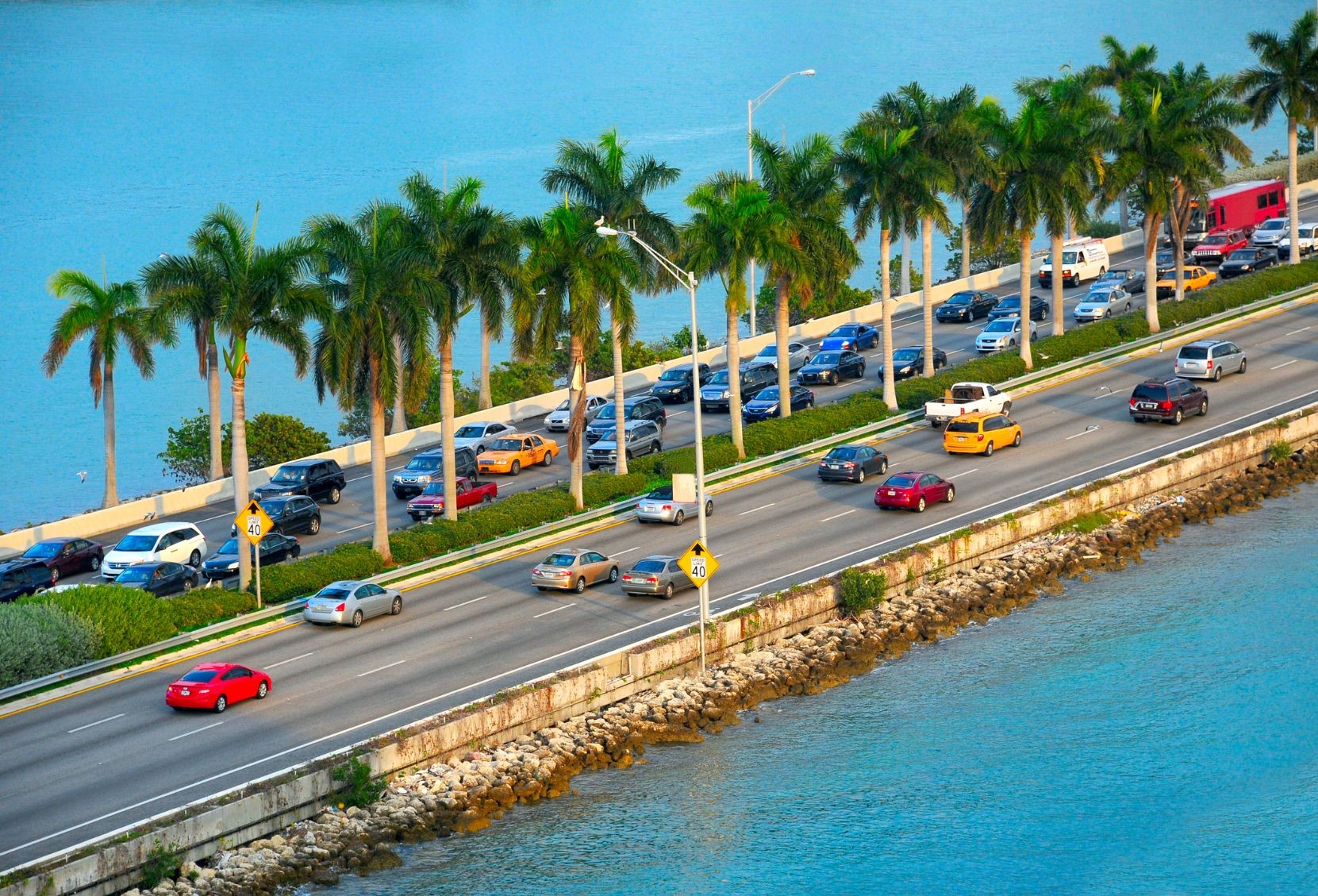 Cars driving down a causeway from Miami to Miami Beach